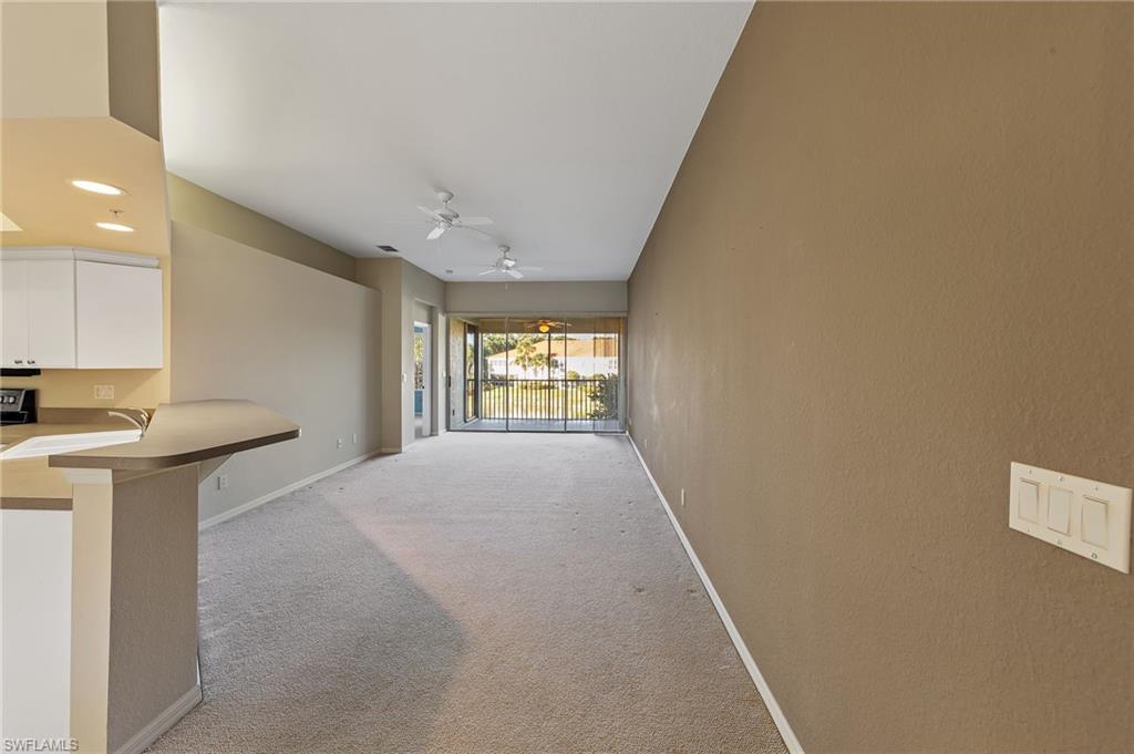 23810 Costa Del Sol Road, Unit 203 Estero, FL 34135 - Photo 3 of 48 Corridor featuring light carpet and recessed lighting