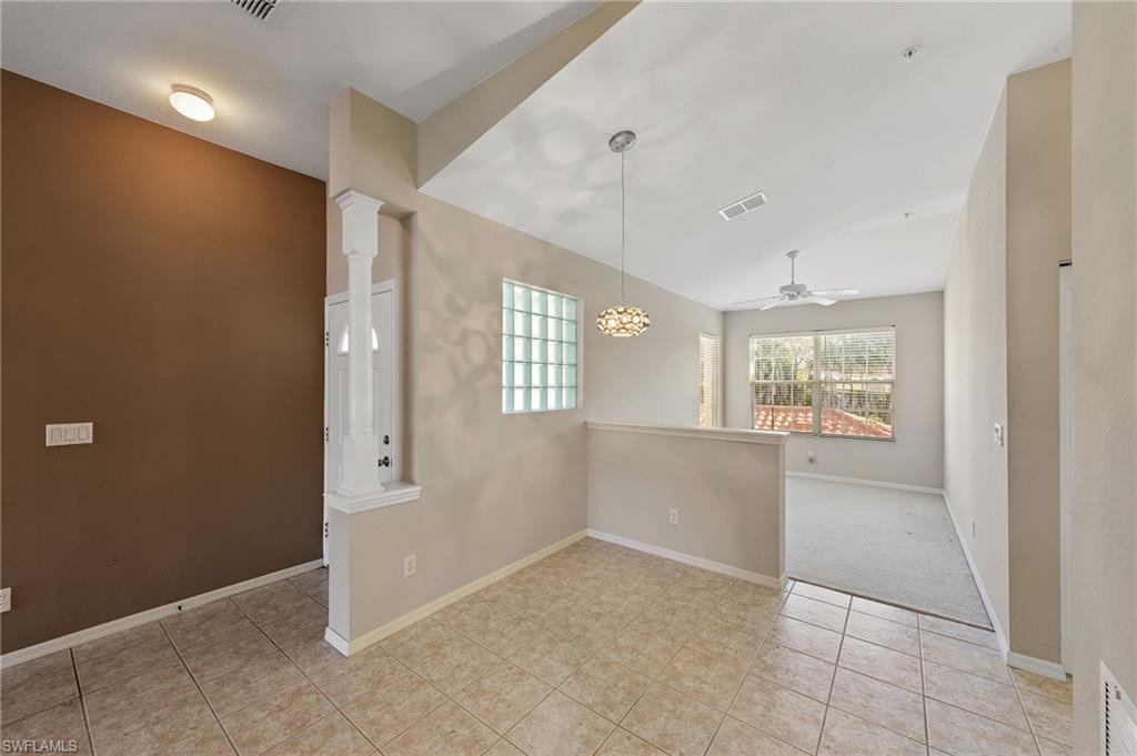 23810 Costa Del Sol Road, Unit 203 Estero, FL 34135 - Photo 10 of 48 Unfurnished room with a ceiling fan and light tile patterned flooring