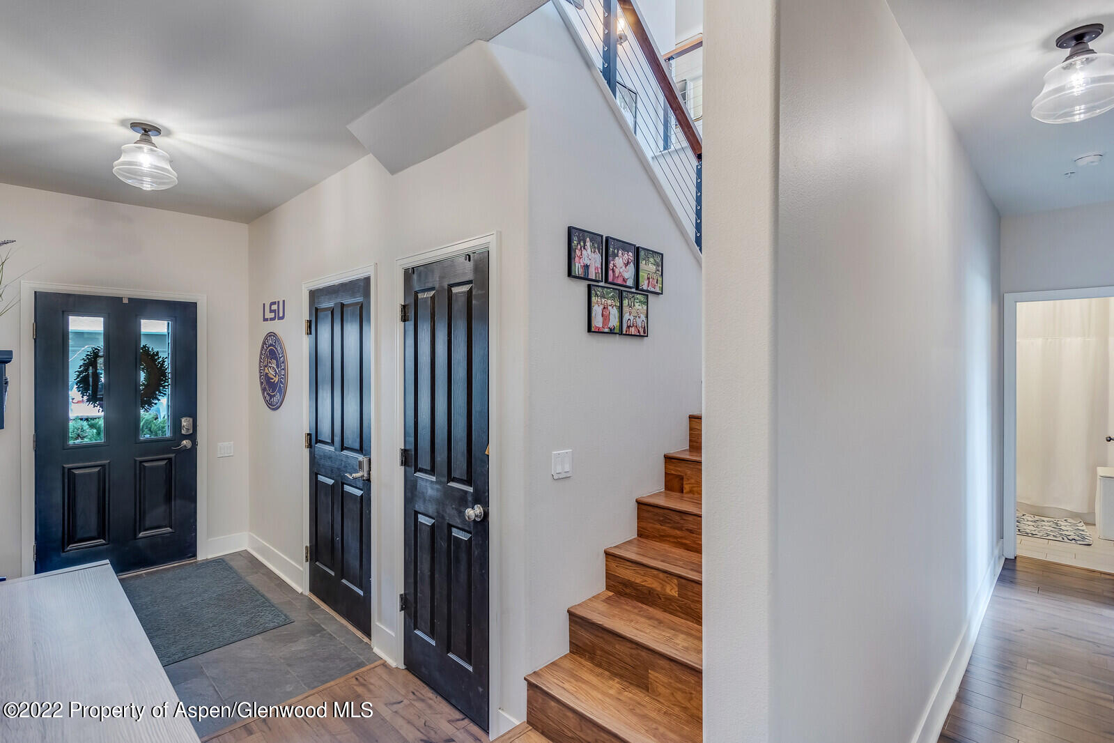 712 Evans Court Basalt, CO 81621 - Photo 5 of 29 a view of a hallway with wooden floor and stairs