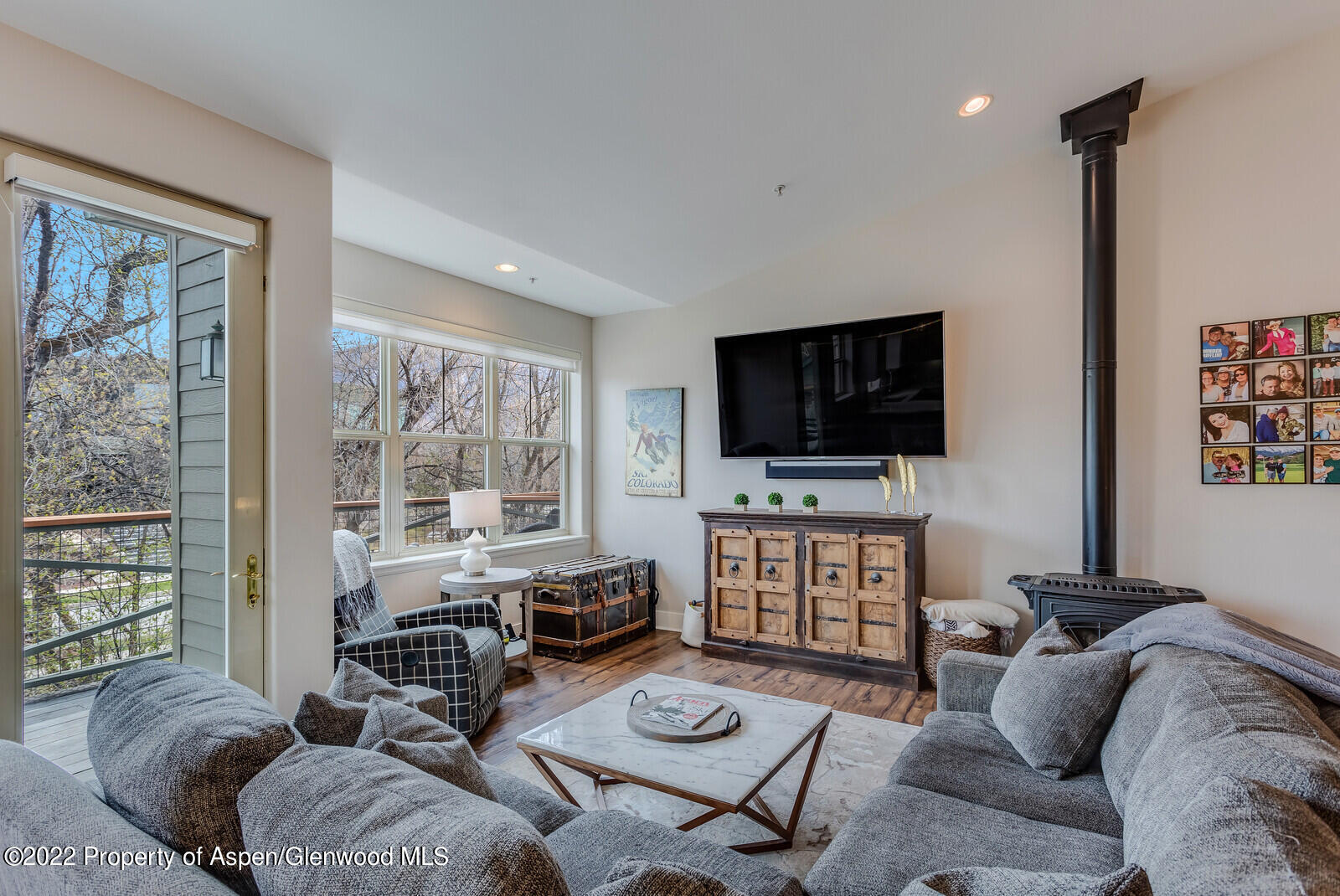 712 Evans Court Basalt, CO 81621 - Photo 6 of 29 a living room with furniture a flat screen tv and a floor to ceiling window