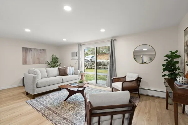 a living room with furniture and a potted plant