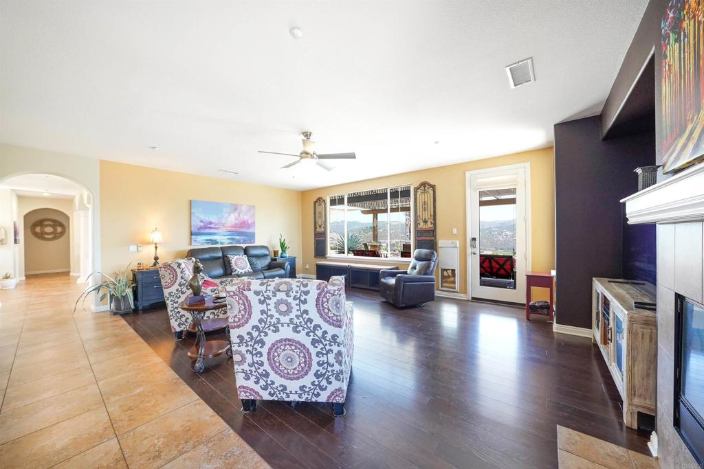 22963 Stokes Road Ramona, CA 92065 - Photo 23 of 57 a living room with furniture and a wooden floor