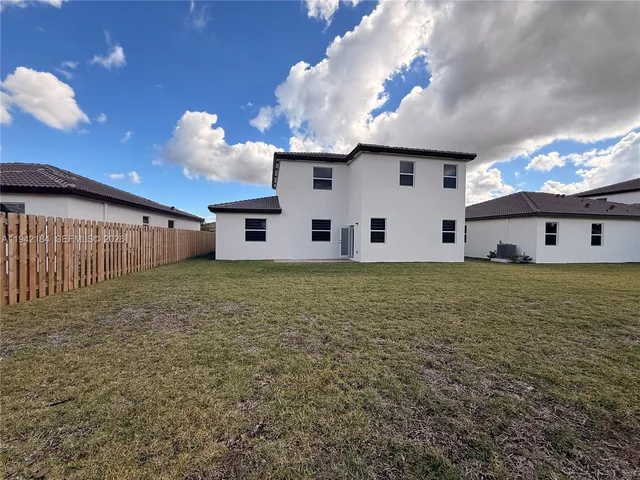 a large tree in front of a house