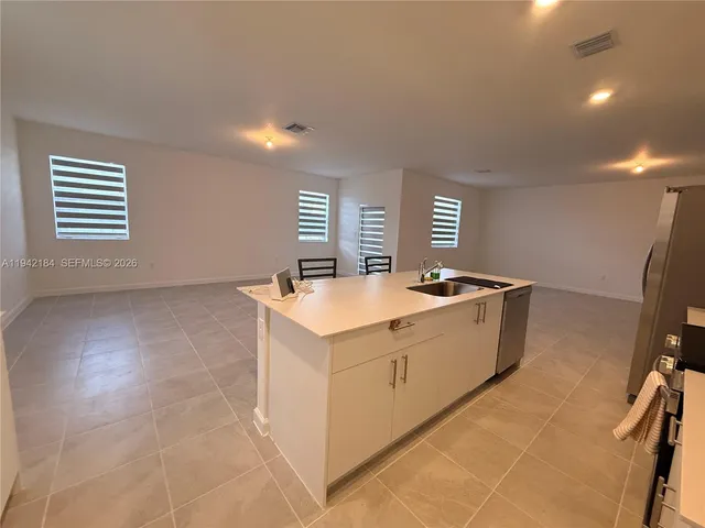 a spacious bathroom with a sink a mirror and a bathtub