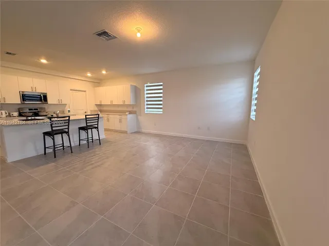 a view of a kitchen and dining room