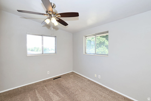 1272 Cook Street Ogden, UT 84404 - Photo 21 of 46 Carpeted room with light gray walls, two windows, and a ceiling fan with integrated lighting