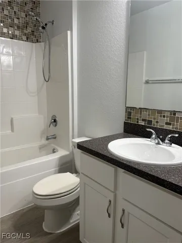 a utility room with wooden floor washer and dryer