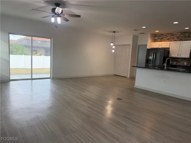 a view of kitchen with refrigerator stove microwave and cabinets