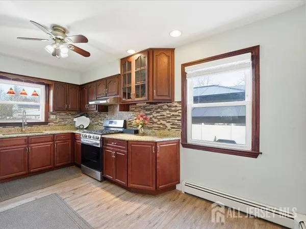 a kitchen with stainless steel appliances granite countertop a stove and cabinets