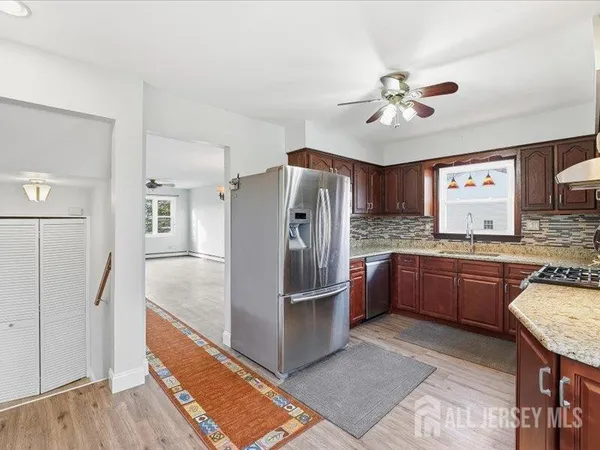 a kitchen with stainless steel appliances granite countertop a refrigerator and a sink