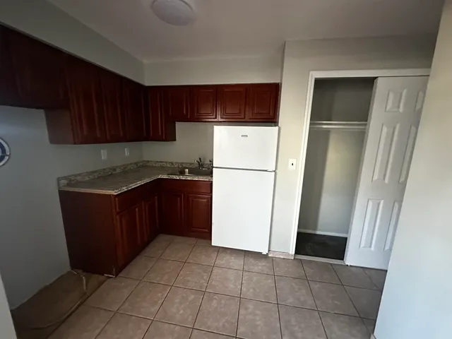 a kitchen with a refrigerator and a sink