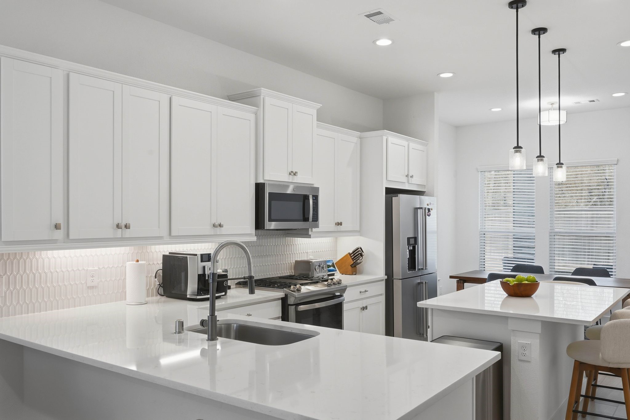 17907 Purple Amaranth Conroe, TX 77385 - Photo 11 of 30 a kitchen with stainless steel appliances a sink a stove a refrigerator a center island and cabinets