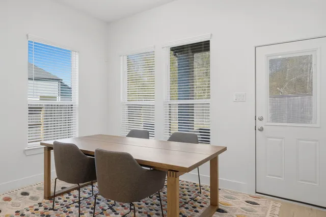 a view of a dining room with furniture and windows