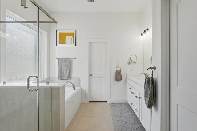 a en suite bathroom with a granite countertop shower
