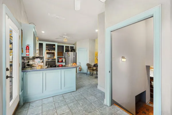 a kitchen with stainless steel appliances granite countertop a refrigerator and a sink