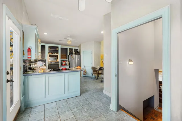 a kitchen with stainless steel appliances granite countertop a refrigerator and a sink