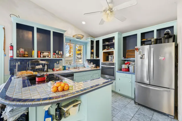 a kitchen with stainless steel appliances granite countertop a sink and cabinets