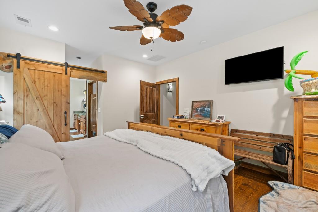 1688 Mulberry Circle Jasper, GA 30143 - Photo 27 of 90 a bedroom with a bed and a flat screen tv