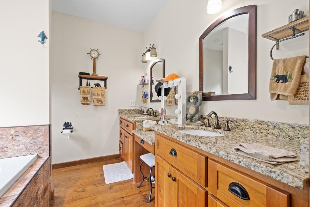 1688 Mulberry Circle Jasper, GA 30143 - Photo 31 of 90 a bathroom with a granite countertop sink and a mirror