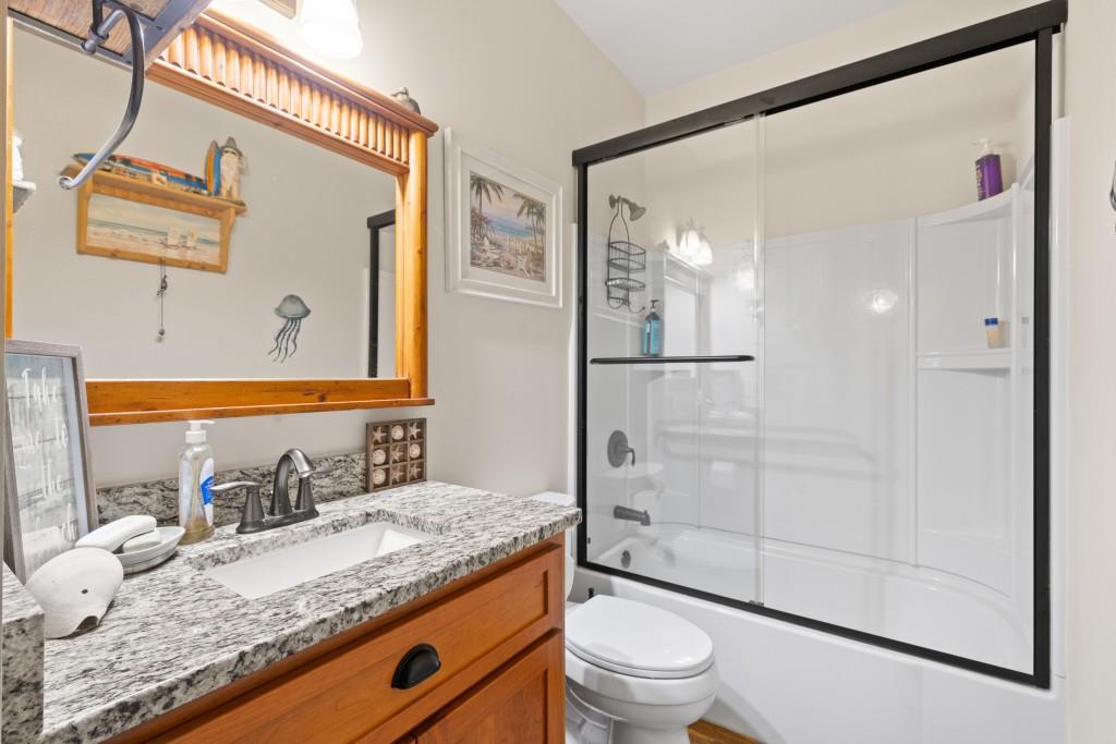 1688 Mulberry Circle Jasper, GA 30143 - Photo 36 of 90 a bathroom with a granite countertop sink mirror vanity and toilet