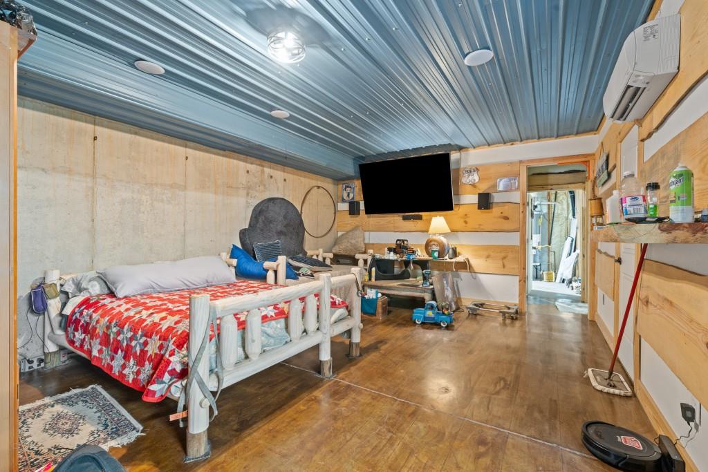 1688 Mulberry Circle Jasper, GA 30143 - Photo 44 of 90 a bedroom with a bed a couch and a flat tv screen