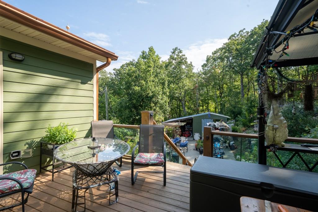 1688 Mulberry Circle Jasper, GA 30143 - Photo 62 of 90 a balcony with wooden floor table and chairs