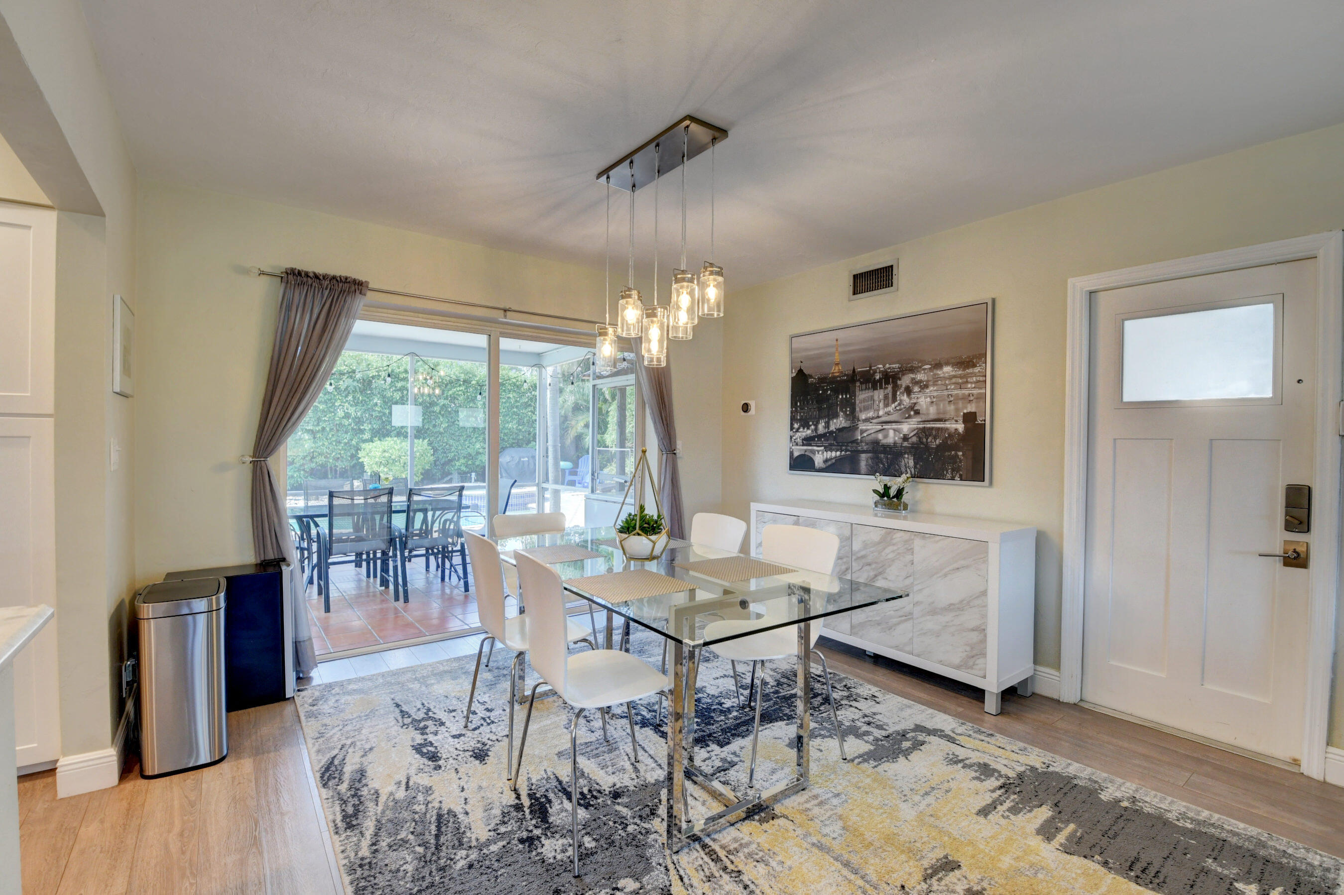 956 Southwest 4th Street Boca Raton, FL 33486 - Photo 18 of 52 a living room with furniture a chandelier and a table