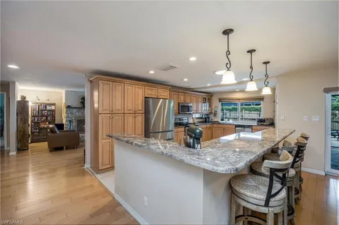 a kitchen with granite countertop a table and chairs in it