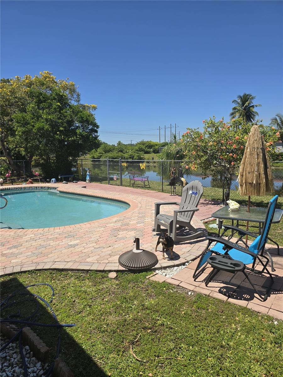 10935 Gable Street Boca Raton, FL 33428 - Photo 2 of 31 a view of a swimming pool and lounge chairs