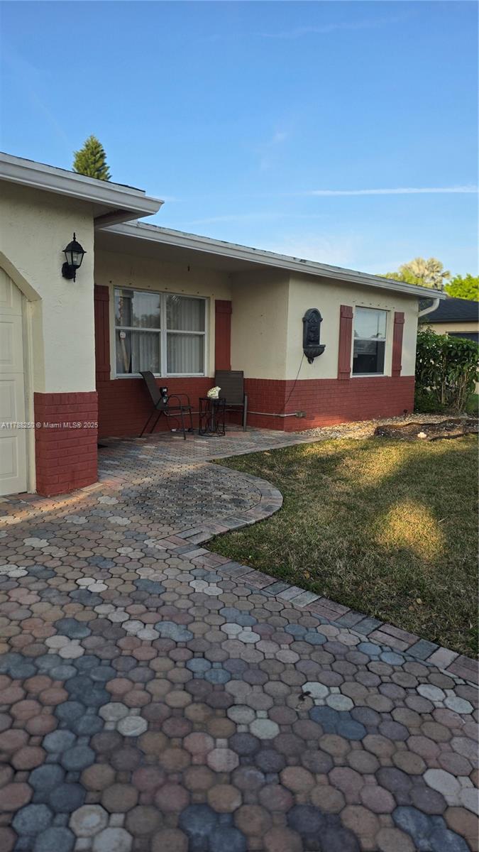 10935 Gable Street Boca Raton, FL 33428 - Photo 31 of 31 a front view of house with yard outdoor seating and barbeque oven