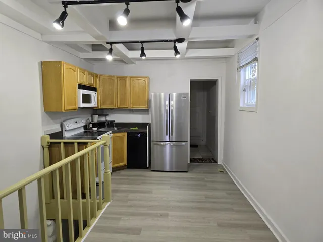 a kitchen with stainless steel appliances granite countertop a refrigerator a stove a sink dishwasher and a refrigerator