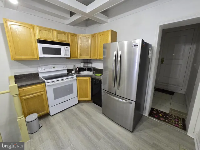 a view of a kitchen with a sink and cabinets