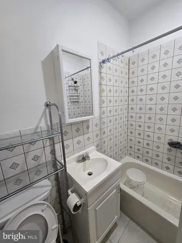a bathroom with a sink a bathtub and shower