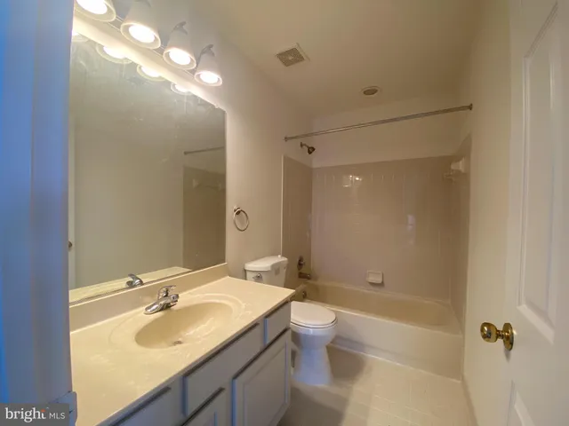 a bathroom with a sink toilet tub and shower