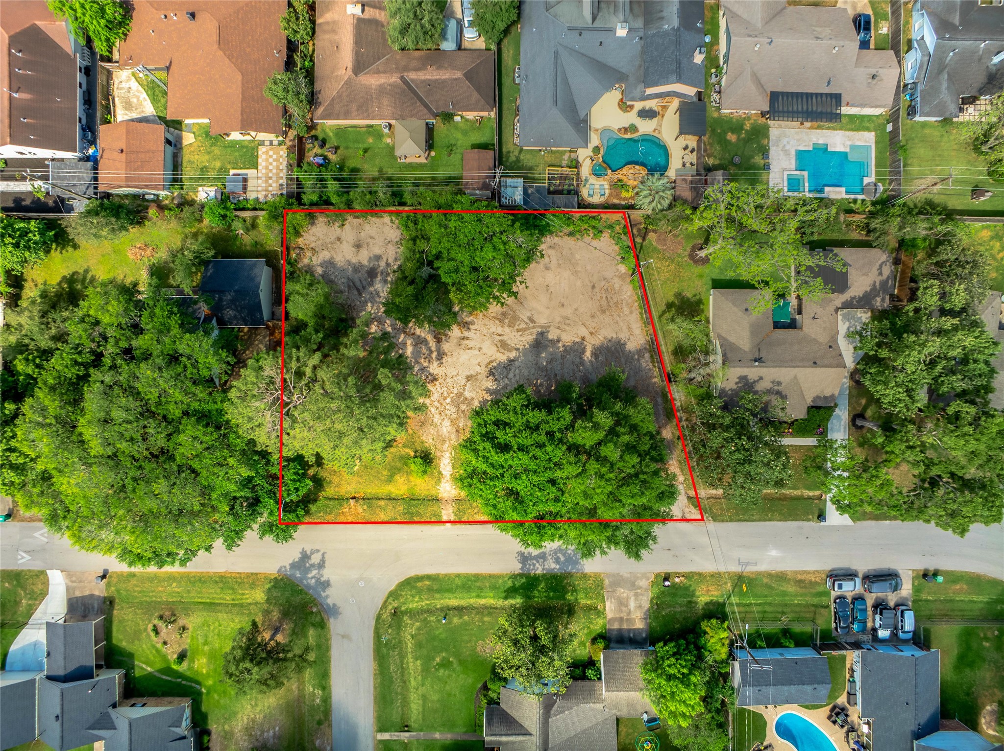 an aerial view of residential houses with outdoor space and street view