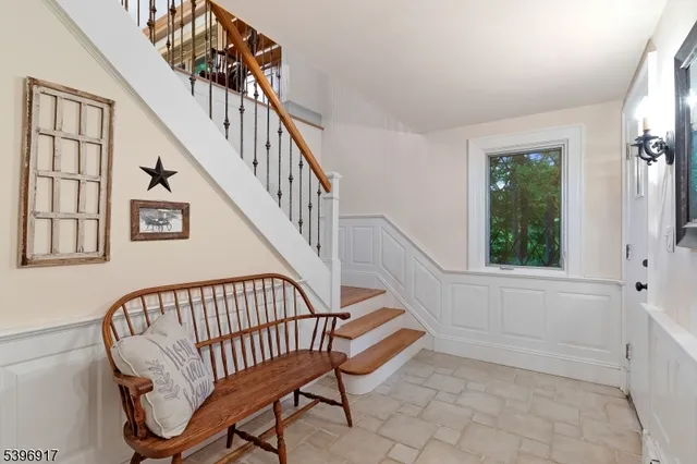 a view of entryway with a window and wooden floor