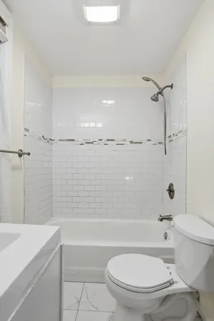 a bathroom with a toilet sink and shower