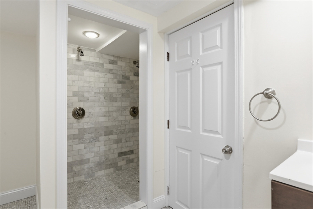 13 Howard Street, Unit 1 Cambridge, MA 02139 - Photo 16 of 21 a bathroom with a glass shower door