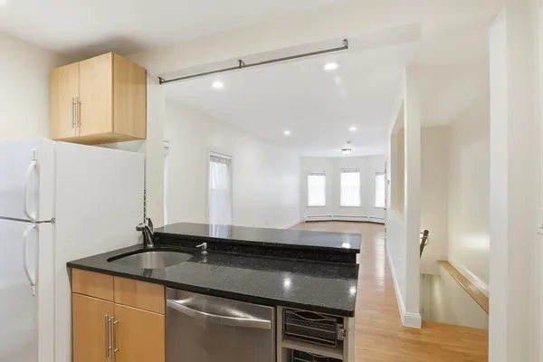 a kitchen with a sink and a refrigerator
