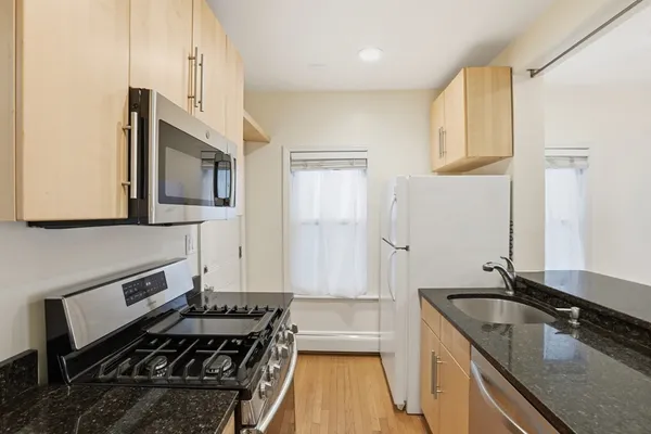 a kitchen that has a sink and a stove