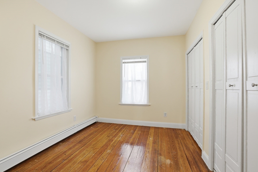 13 Howard Street, Unit 1 Cambridge, MA 02139 - Photo 8 of 21 an empty room with wooden floor and windows