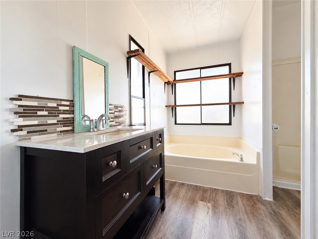 1611 West Blosser Ranch Road Pahrump, NV 89060 - Photo 19 of 25 A well-appointed bathroom with a vanity and a relaxing tub, offering comfort and convenience.