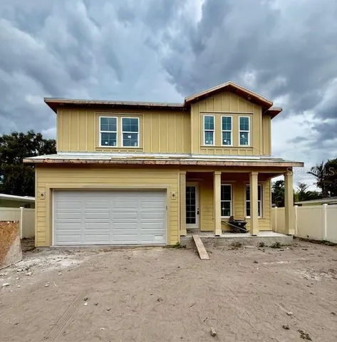 a front view of a house with basket ball court and garage