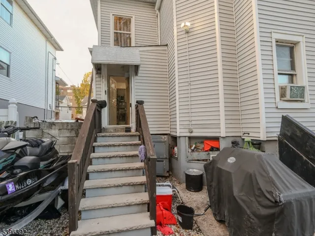 a view of a patio with two chairs and a potted plant
