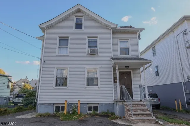 a front view of a house with stairs