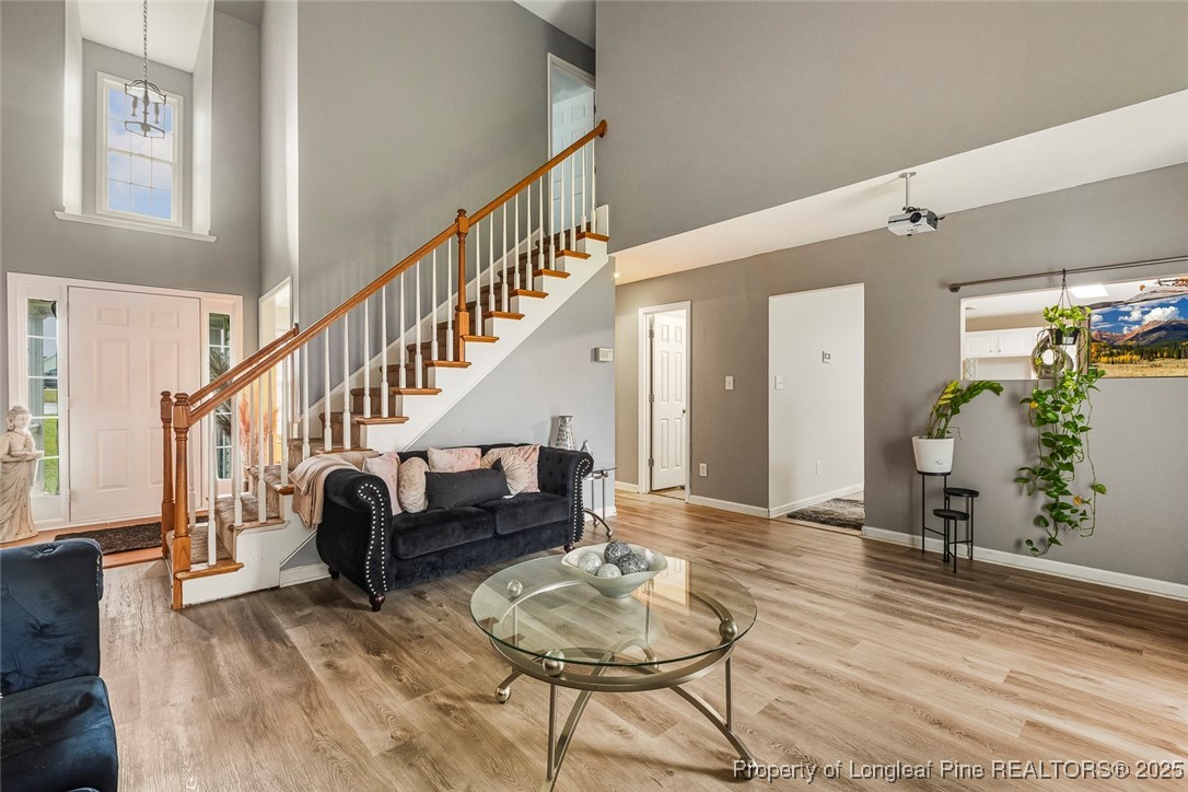 10 Pender Road Spring Lake, NC 28390 - Photo 11 of 23 a living room with couches and a dining table with wooden floor