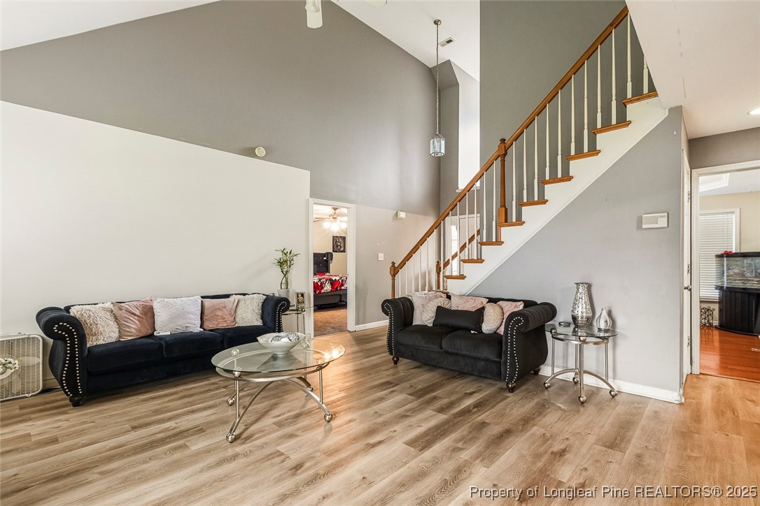 10 Pender Road Spring Lake, NC 28390 - Photo 12 of 23 a living room with furniture and stairs with wooden floor