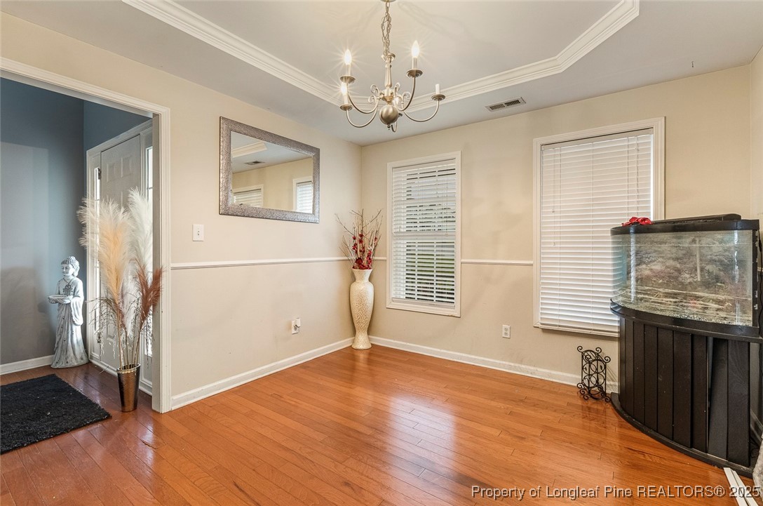 10 Pender Road Spring Lake, NC 28390 - Photo 6 of 23 an empty room with wooden floor and windows