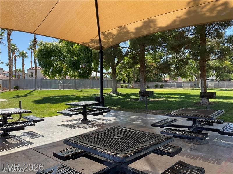 3318 North Decatur Boulevard, Unit 2152 Las Vegas, NV 89130 - Photo 40 of 58 A tranquil park scene with shaded picnic tables, ideal for community gatherings and outdoor relaxation.