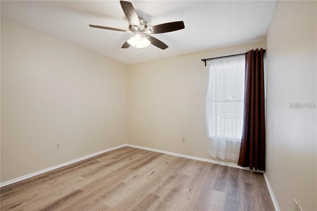 4006 Angel Oak Court, Unit 202 Tampa, FL 33613 - Photo 11 of 15 wooden floor in an empty room with a window